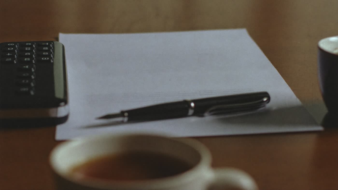 A desk with a printed document and a phone