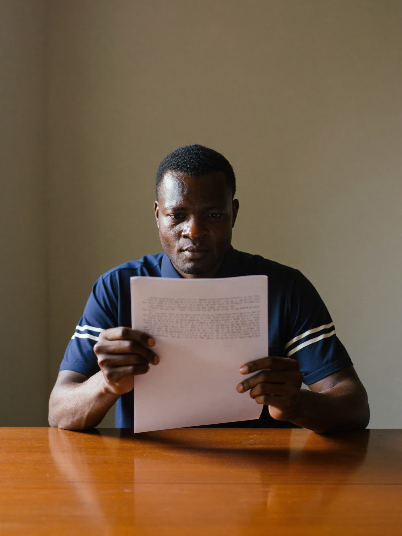 A professional reading a document at a desk